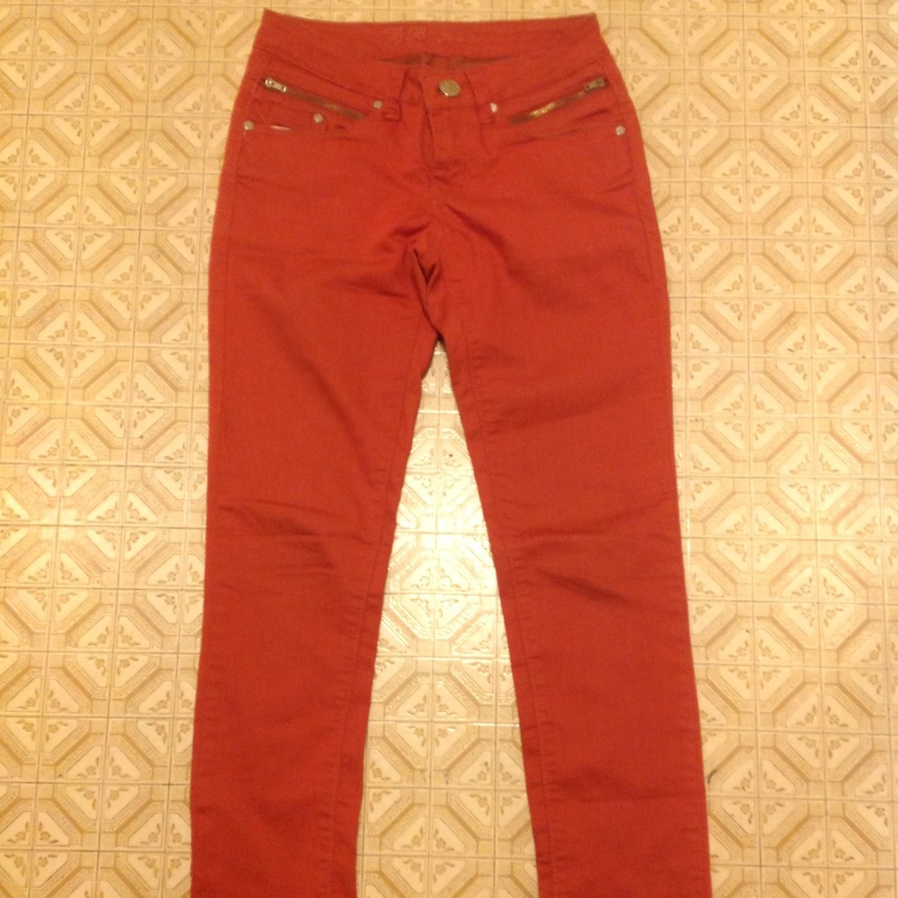 Orange skinny jeans with zippers